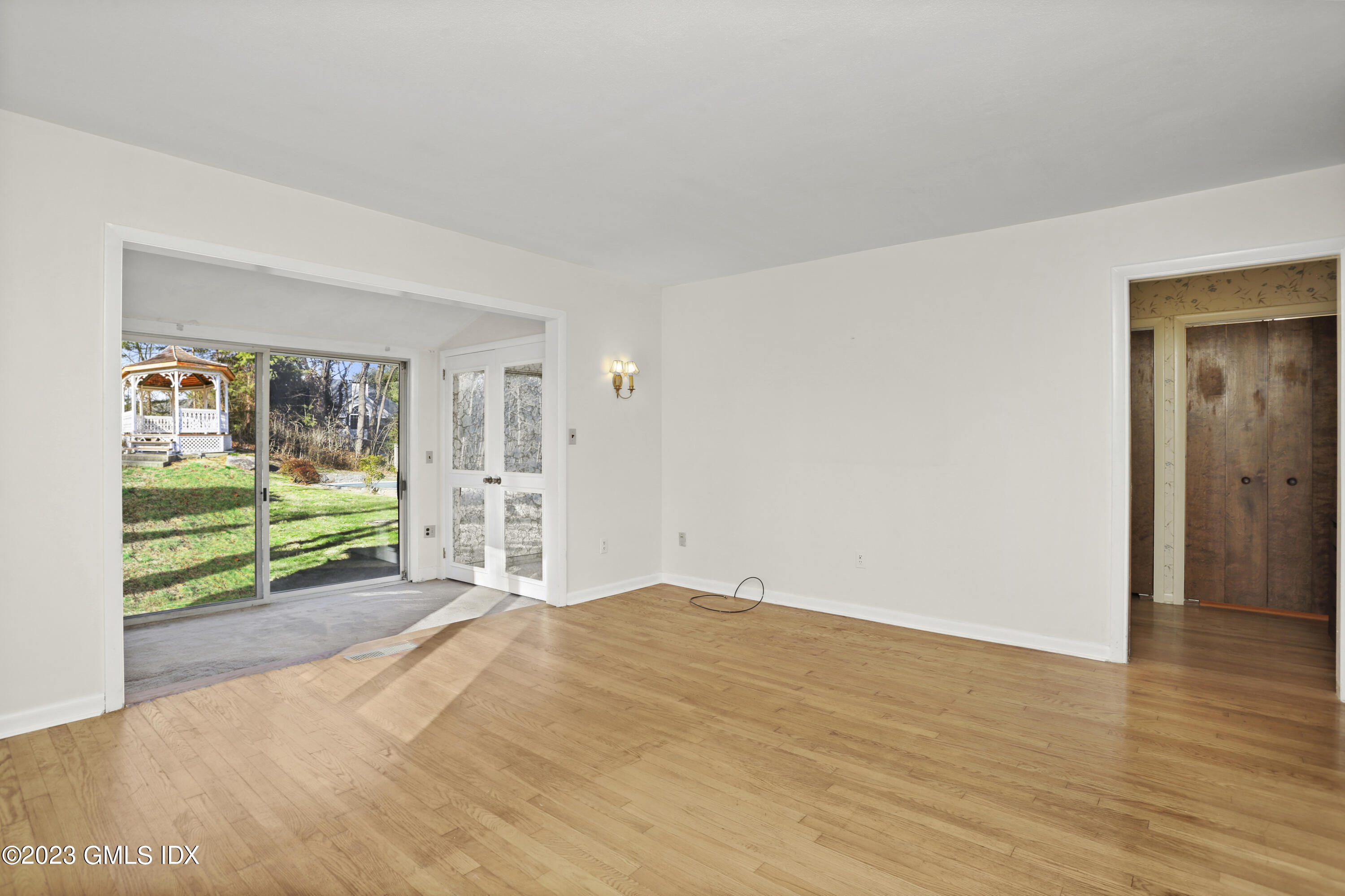 28 Intervale Road Stamford, CT 06905 - Photo 12 of 20 a view of an empty room with wooden floor and a window