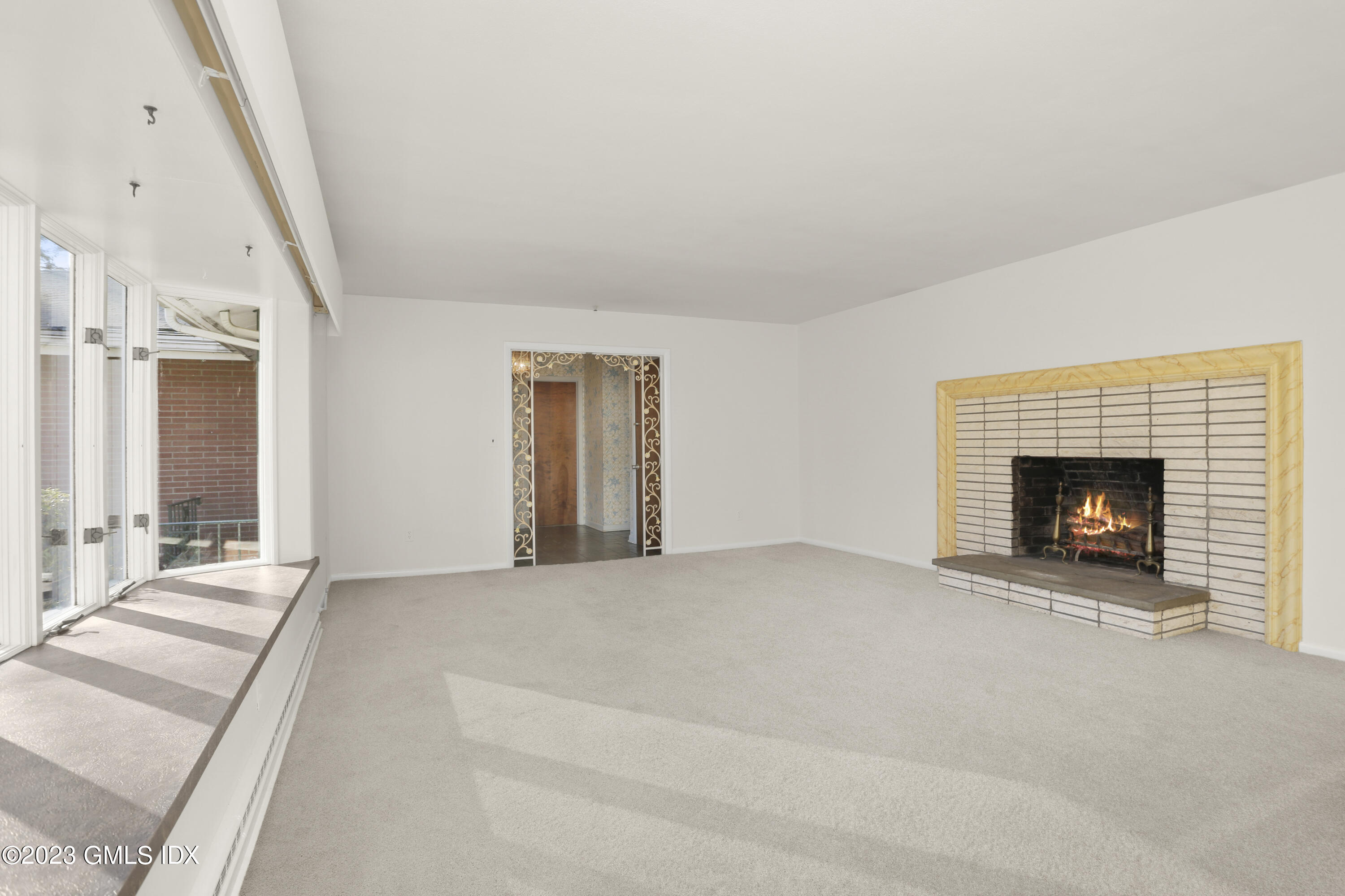 28 Intervale Road Stamford, CT 06905 - Photo 3 of 20 a view of an empty room with a fireplace and a window