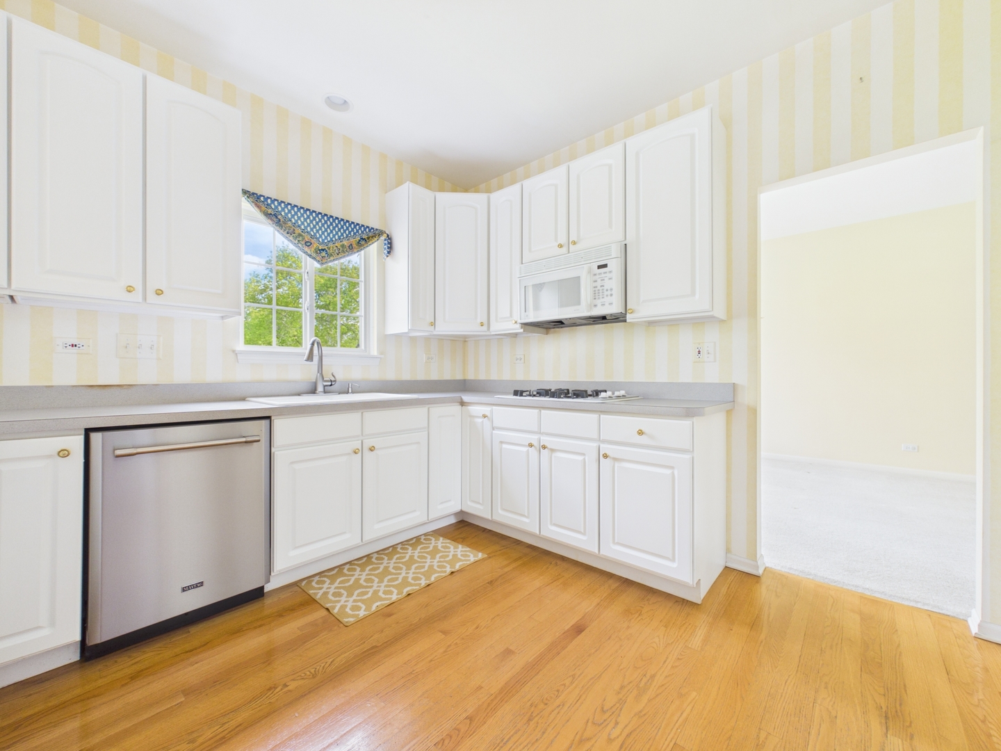 7486 Abbey Road Gurnee, IL 60031 - Photo 9 of 35 a kitchen with a sink cabinets and window