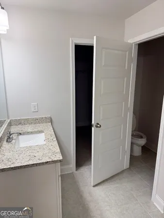 a white toilet sitting next to a white sink