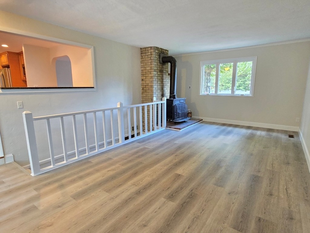 26 Wenzell Road Ashland, MA 01721 - Photo 20 of 33 a view of an empty room with wooden floor and a window