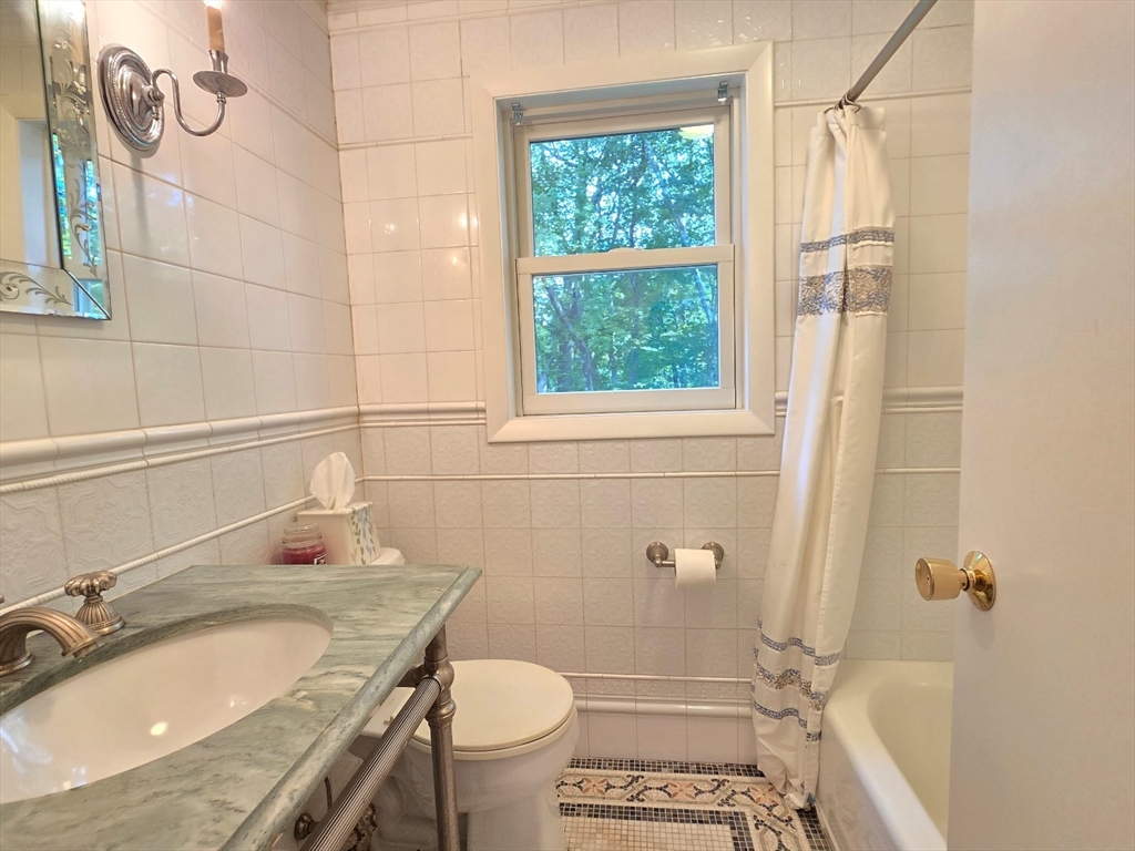 26 Wenzell Road Ashland, MA 01721 - Photo 27 of 33 a bathroom with a granite countertop sink toilet and shower