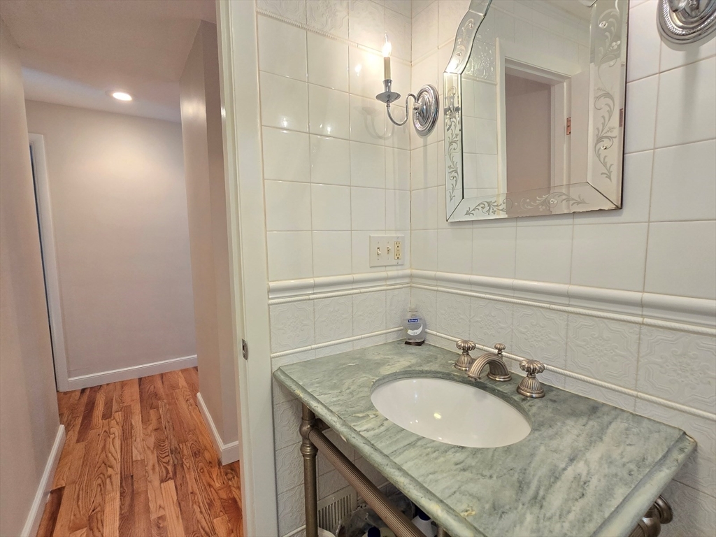 26 Wenzell Road Ashland, MA 01721 - Photo 29 of 33 a bathroom with a granite countertop sink and a mirror