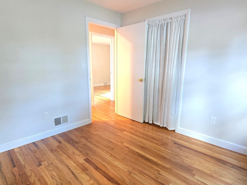 26 Wenzell Road Ashland, MA 01721 - Photo 31 of 33 an empty room with wooden floor and windows