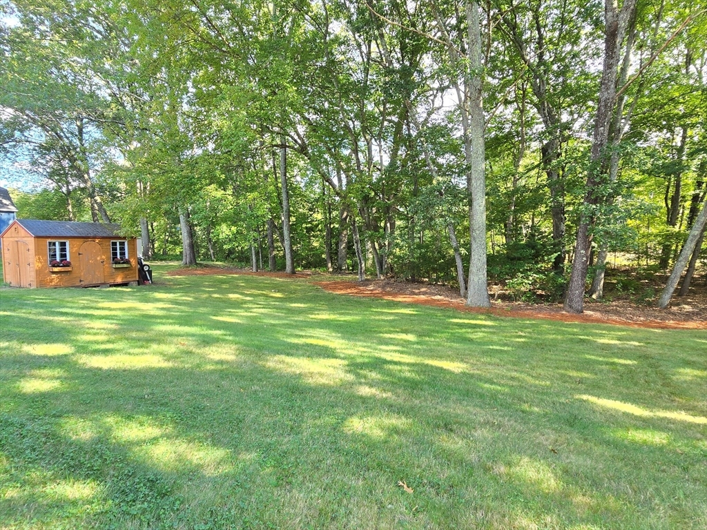 26 Wenzell Road Ashland, MA 01721 - Photo 4 of 33 a backyard of a house with table and chairs