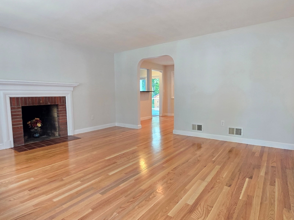 26 Wenzell Road Ashland, MA 01721 - Photo 8 of 33 a view of empty room with wooden floor and fireplace