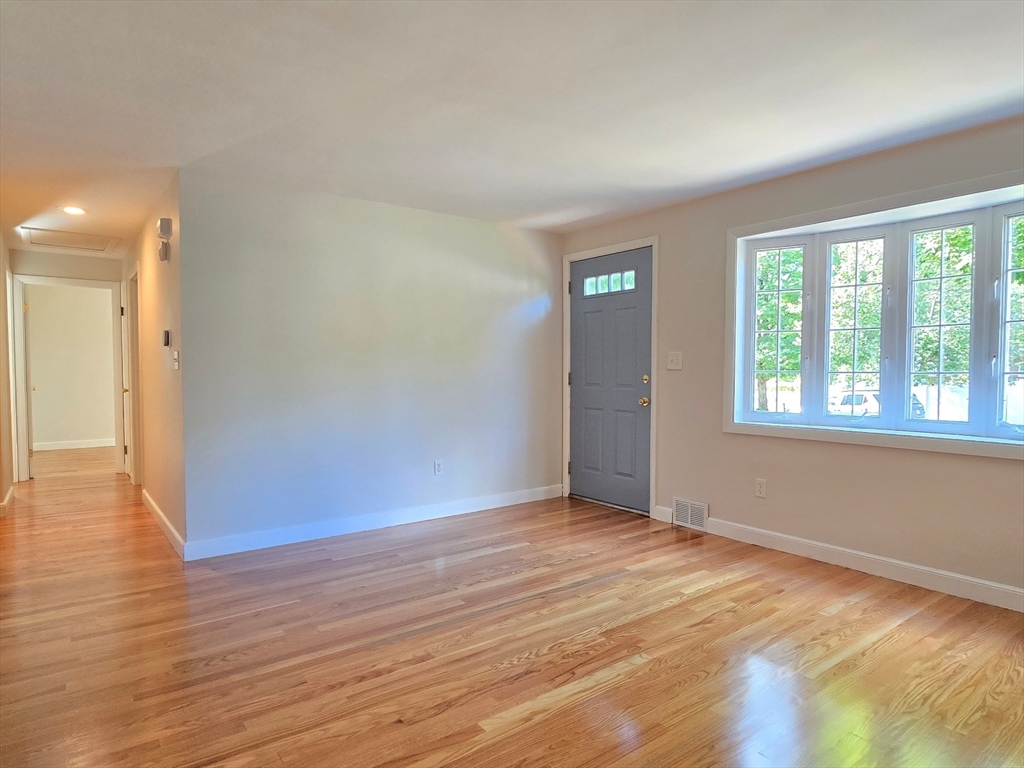 26 Wenzell Road Ashland, MA 01721 - Photo 10 of 33 a view of an empty room with wooden floor and a window