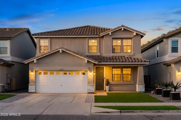 a front view of a house with a yard
