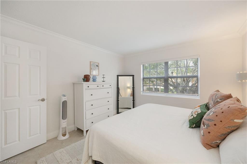 72 7th Street South, Unit 206 Naples, FL 34102 - Photo 17 of 38 a bedroom with a bed and a window