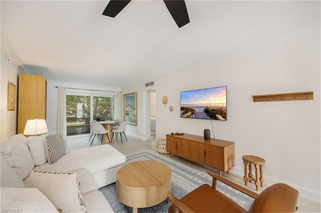 72 7th Street South, Unit 206 Naples, FL 34102 - Photo 3 of 38 a living room with furniture and a flat screen tv