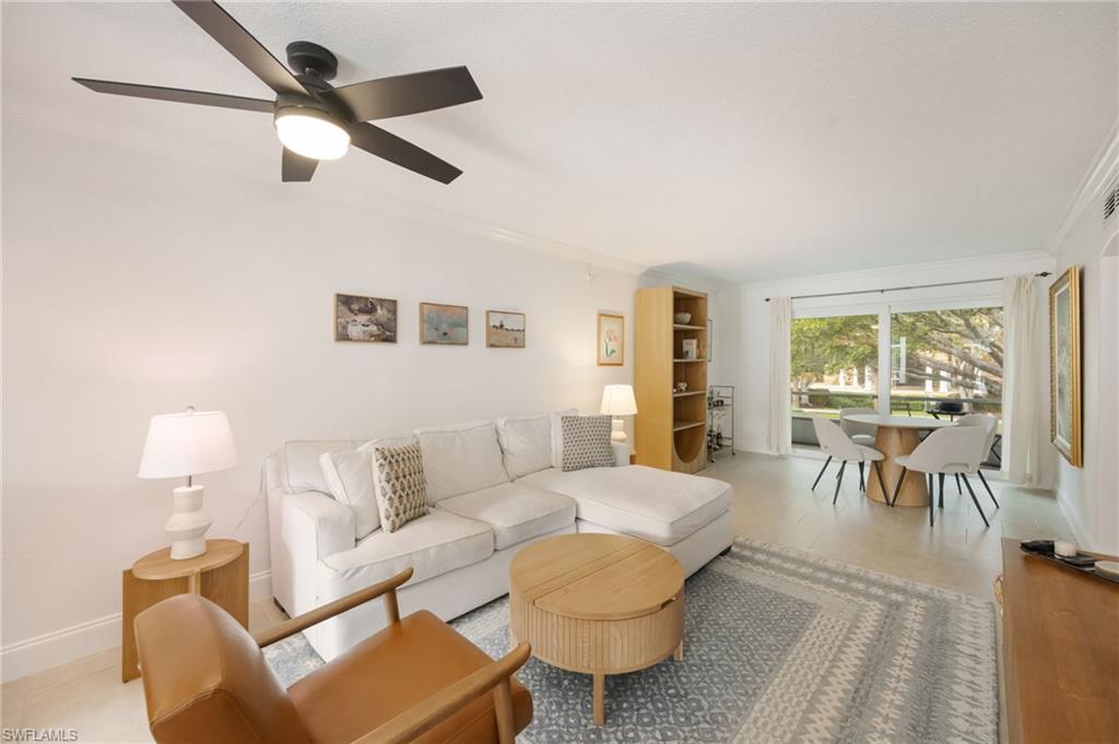 72 7th Street South, Unit 206 Naples, FL 34102 - Photo 4 of 38 a living room with furniture and a large window