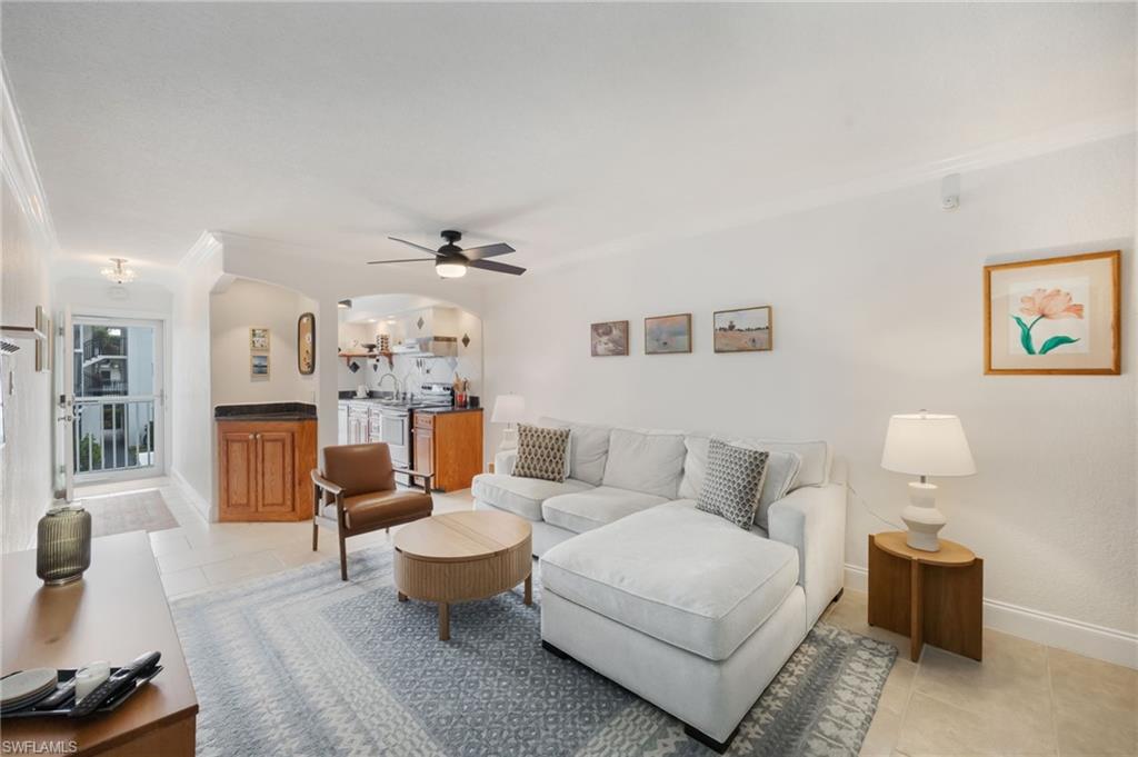 72 7th Street South, Unit 206 Naples, FL 34102 - Photo 5 of 38 a living room with furniture a rug and a chandelier