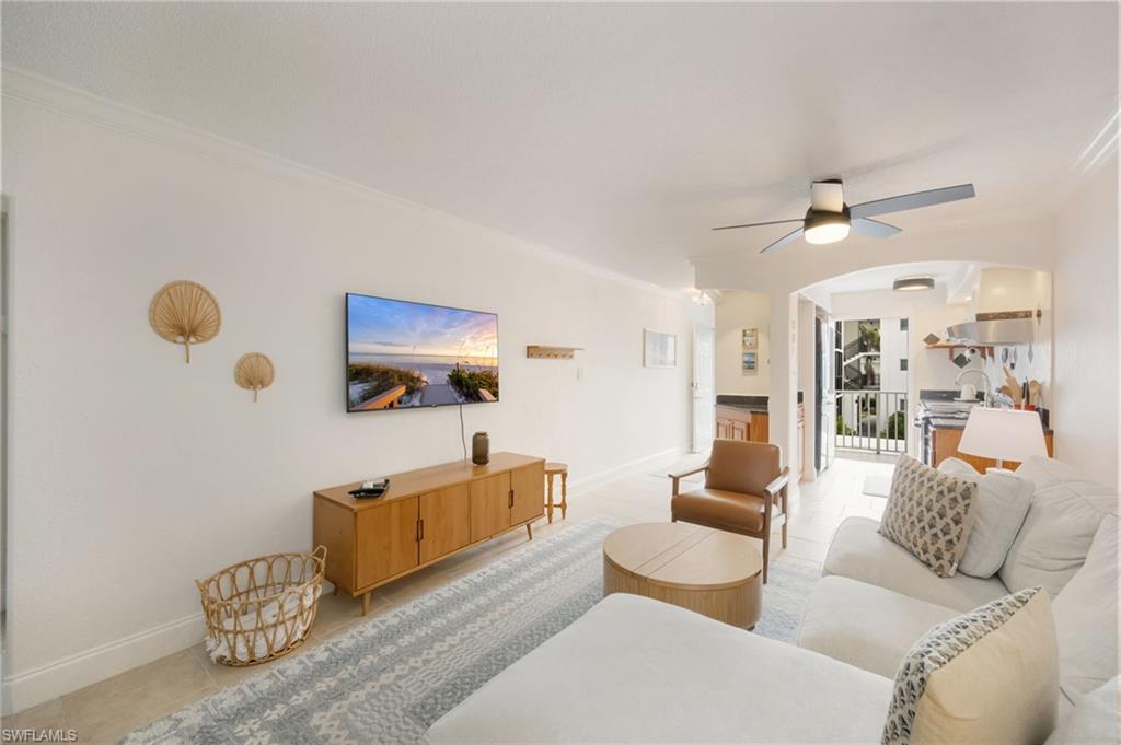 72 7th Street South, Unit 206 Naples, FL 34102 - Photo 7 of 38 a living room with furniture and a chandelier