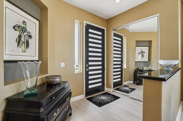 a bathroom with a granite countertop double vanity and a mirror
