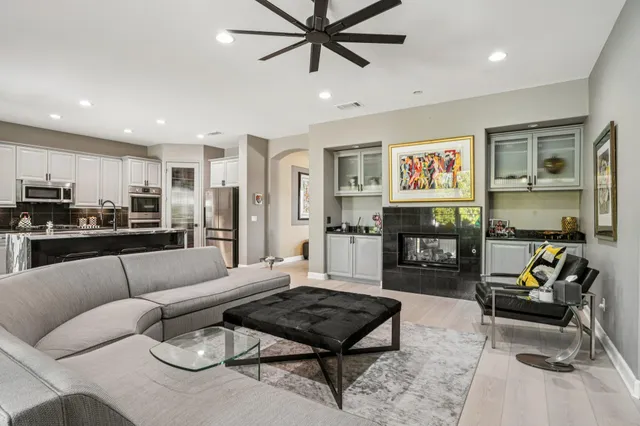 a view of a patio with couches table and chairs and potted plants