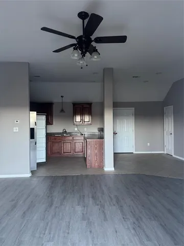 a view of a kitchen with a sink and a refrigerator