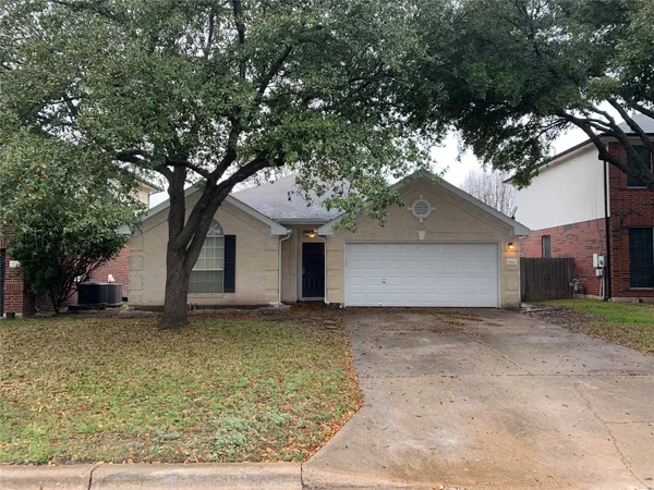 a house that has a tree in front of it