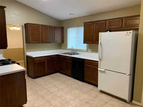 a kitchen with a refrigerator and a sink