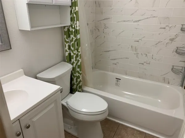 a bathroom with a sink a toilet and bathtub