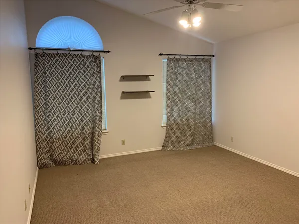 a view of an empty room with a kitchen