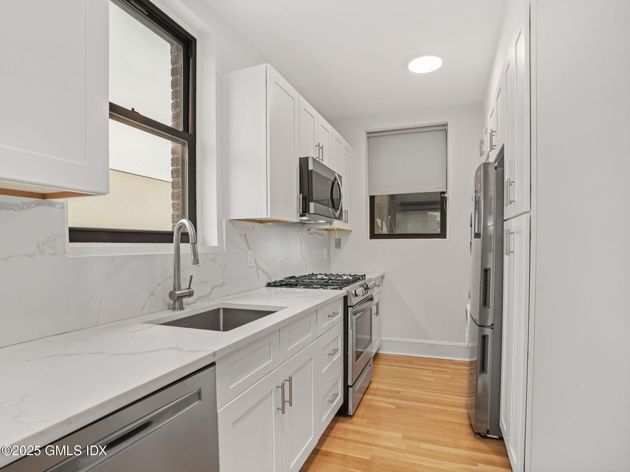 169 Greenwich Avenue, Unit FRONT Greenwich, CT 06830 - Photo 2 of 22 a kitchen with stainless steel appliances granite countertop a sink stove and refrigerator