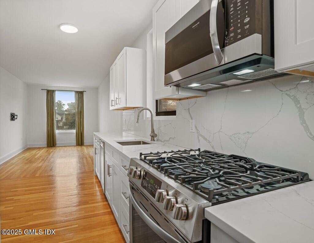 169 Greenwich Avenue, Unit FRONT Greenwich, CT 06830 - Photo 3 of 22 a kitchen with a stove and a microwave