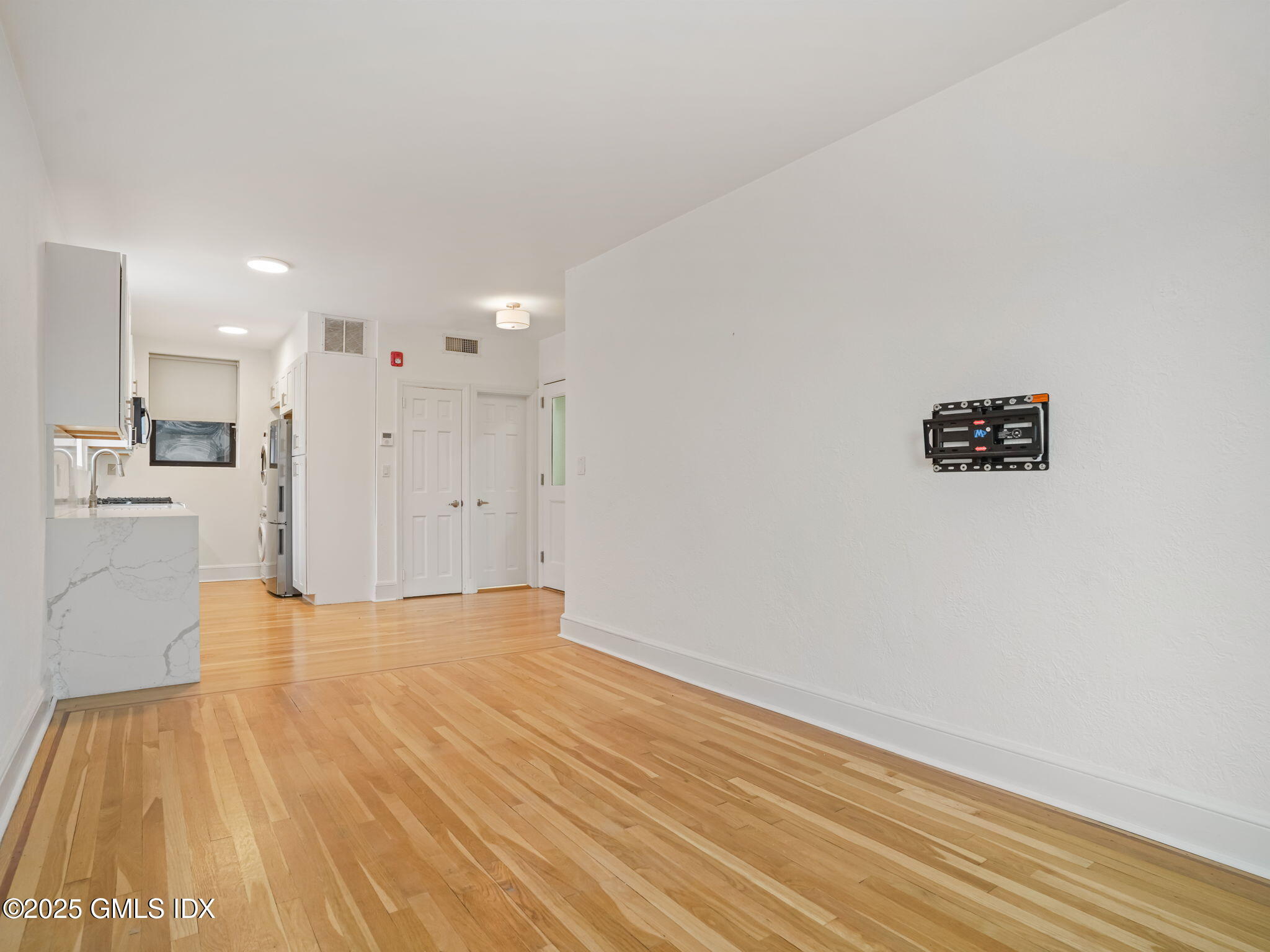 169 Greenwich Avenue, Unit FRONT Greenwich, CT 06830 - Photo 6 of 22 a view of an empty room with wooden floor