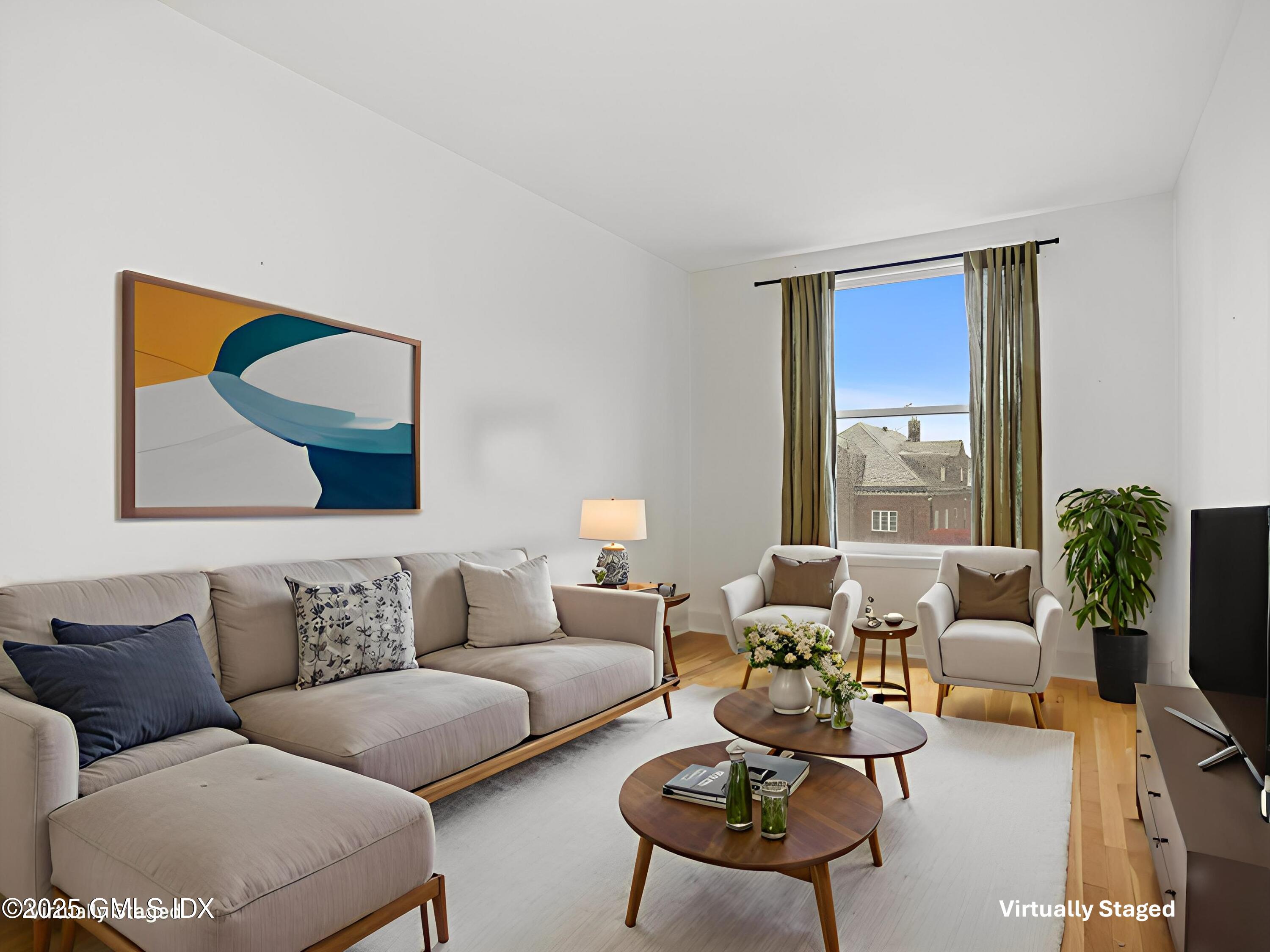 169 Greenwich Avenue, Unit FRONT Greenwich, CT 06830 - Photo 7 of 22 a living room with furniture potted plant and a large window