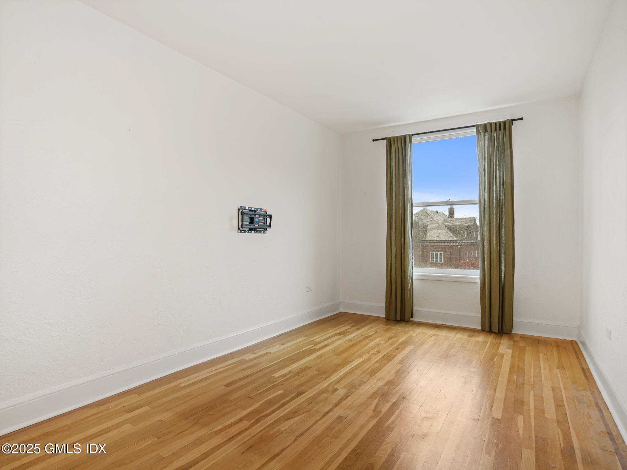 169 Greenwich Avenue, Unit FRONT Greenwich, CT 06830 - Photo 8 of 22 a view of an empty room with wooden floor