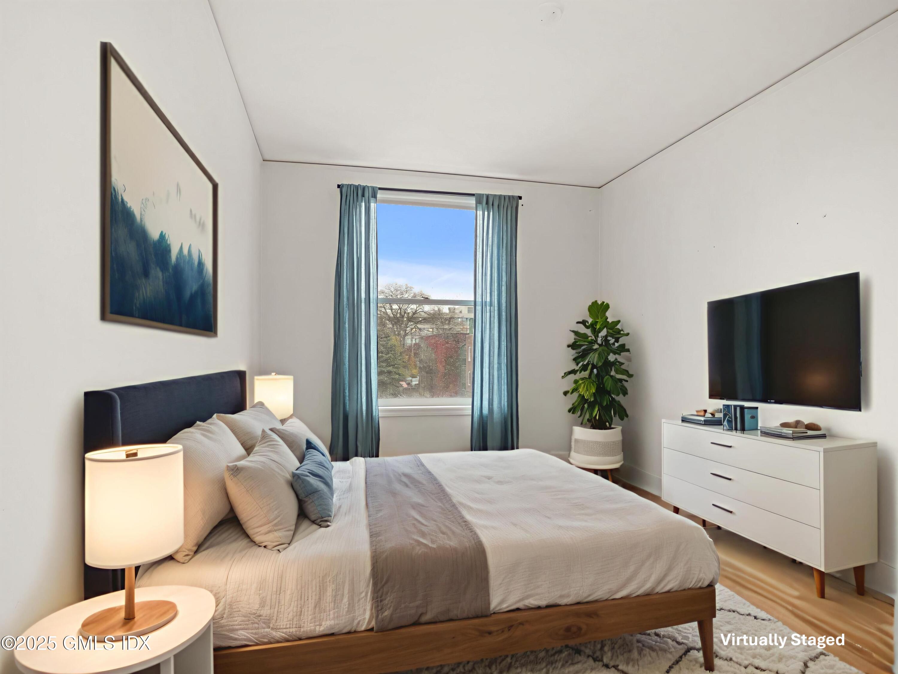 169 Greenwich Avenue, Unit FRONT Greenwich, CT 06830 - Photo 9 of 22 a bedroom with a bed and a flat screen tv