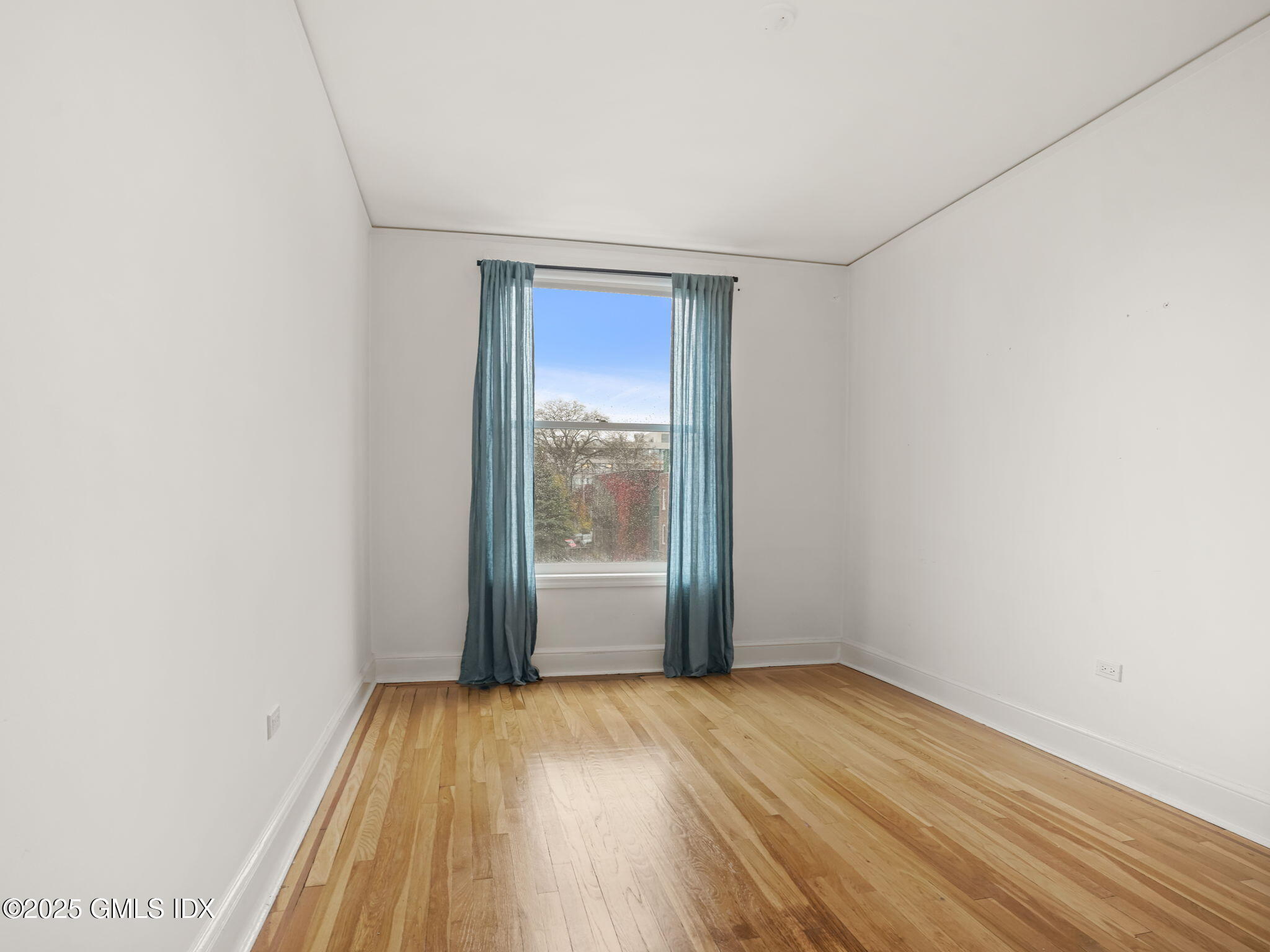 169 Greenwich Avenue, Unit FRONT Greenwich, CT 06830 - Photo 10 of 22 an empty room with wooden floor and windows