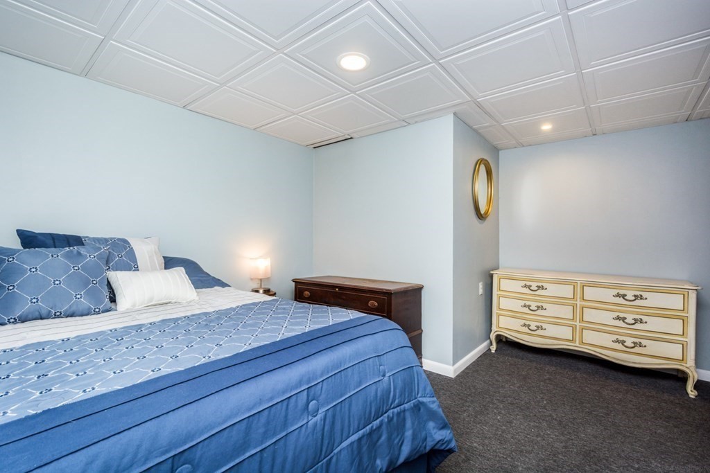 2 Lakeside Avenue Webster, MA 01570 - Photo 17 of 27 a bedroom with a bed and cabinets