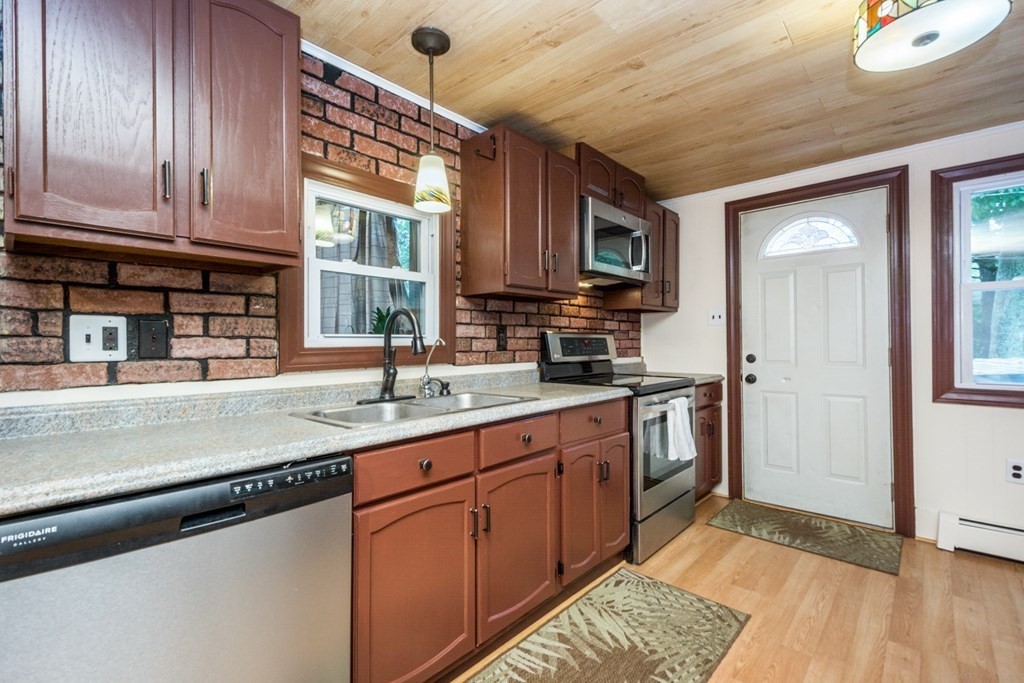 2 Lakeside Avenue Webster, MA 01570 - Photo 9 of 27 a kitchen with stainless steel appliances granite countertop a sink stove and cabinets
