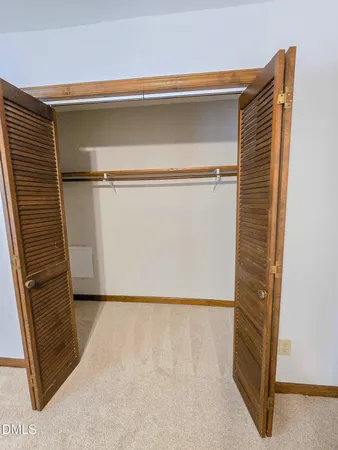a view of closet with wooden floor