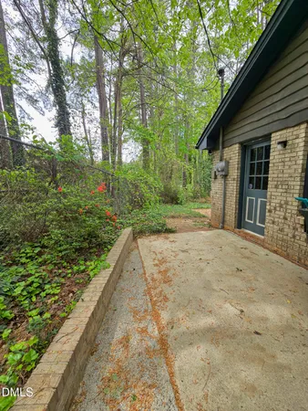a view of a backyard with large trees