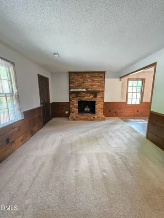 an empty room with furniture and a fireplace