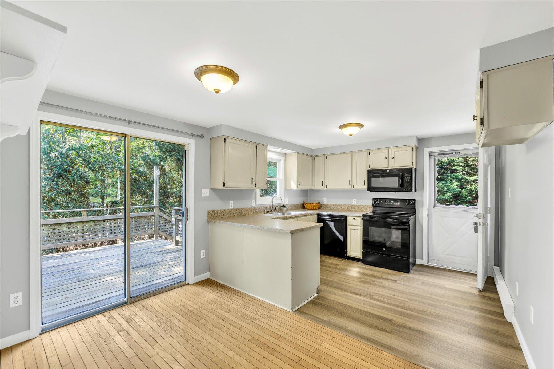 59 Oregon Road Mashpee, MA 02649 - Photo 12 of 34 a kitchen with a refrigerator and a stove top oven
