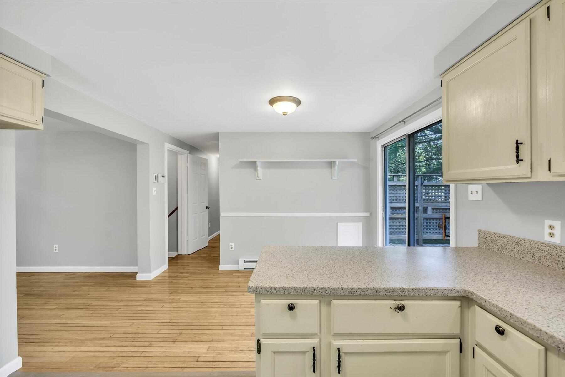 59 Oregon Road Mashpee, MA 02649 - Photo 14 of 34 a kitchen with stainless steel appliances cabinets and wooden floor