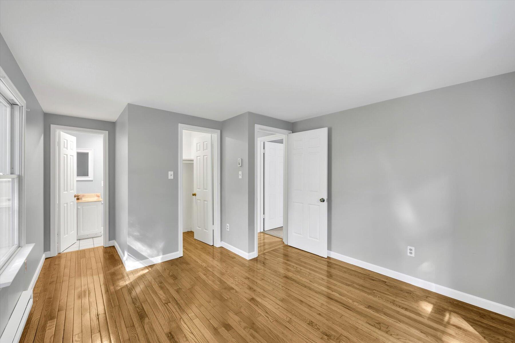 59 Oregon Road Mashpee, MA 02649 - Photo 17 of 34 a view of a bedroom with wooden floor and bathroom