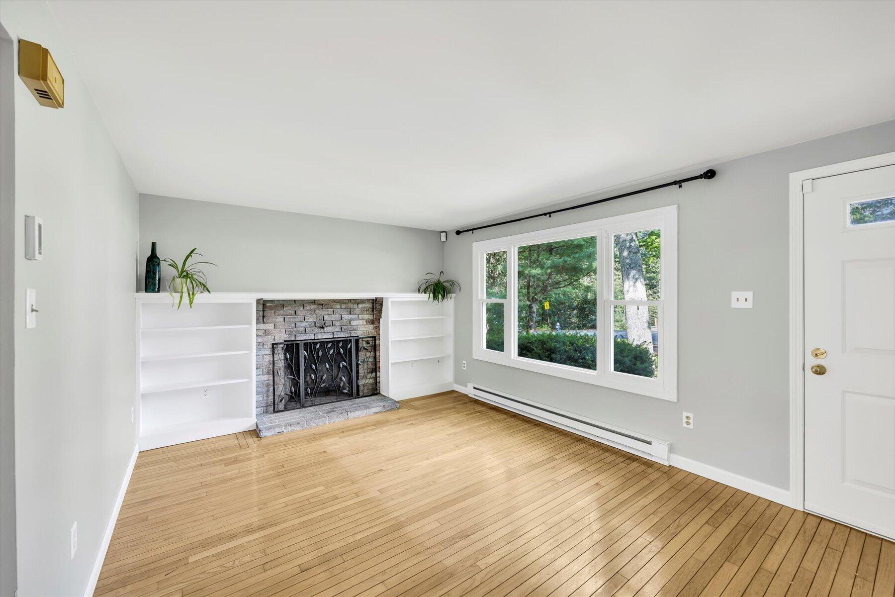 59 Oregon Road Mashpee, MA 02649 - Photo 8 of 34 a view of a livingroom with a fireplace and window