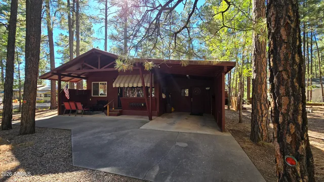 a view of a house with a tree and a yard