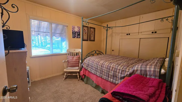 a bedroom with a bed and a window