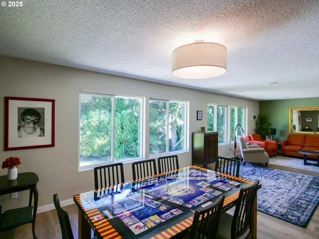 a living room with furniture a rug and a floor to ceiling window