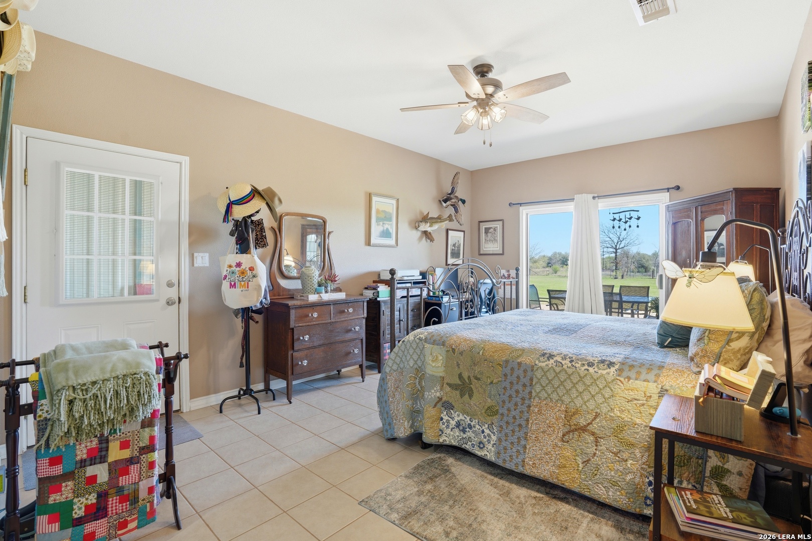 293 Woodrow Center Road Kingsbury, TX 78638 - Photo 20 of 50 a bedroom with a bed and a chandelier