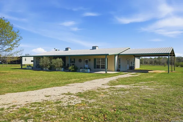 a front view of a house with a garden and porch