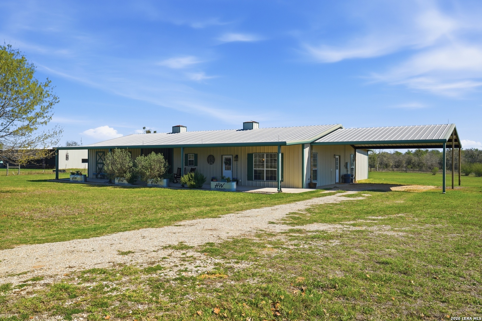 293 Woodrow Center Road Kingsbury, TX 78638 - Photo 2 of 50 a front view of a house with a garden and porch