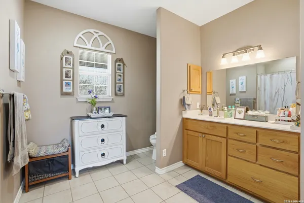 a spacious bathroom with a double vanity sink a mirror and a bathtub