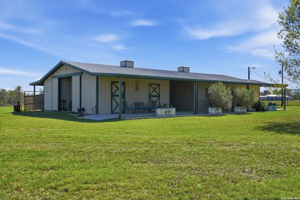 a front view of house with yard and outdoor seating
