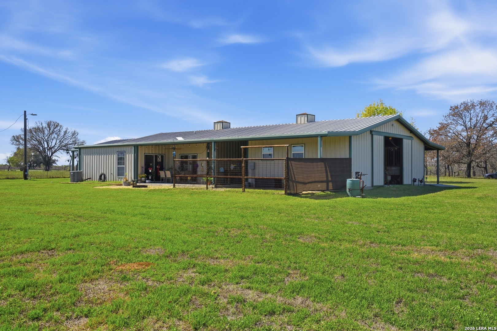 293 Woodrow Center Road Kingsbury, TX 78638 - Photo 28 of 50 a front view of a house with a garden