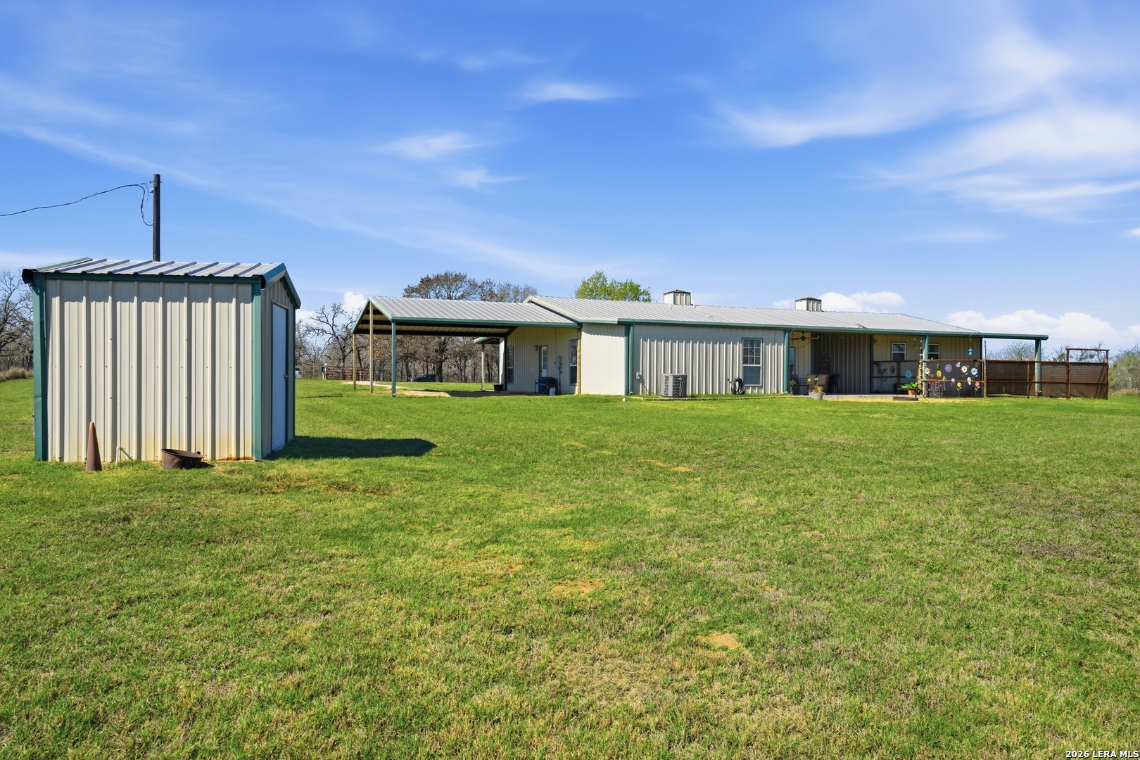 293 Woodrow Center Road Kingsbury, TX 78638 - Photo 30 of 50 a front view of a house with a garden